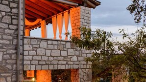 A stone building with a balcony and a stone fireplace. - Once Upon a Time - A Castle of Magical Sunsets (Kalamata)