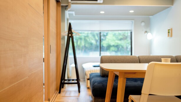 A modern room with a wooden floor, a sofa, a table, and a tripod. - Akasaka Roppongi area with elevator Quiet high-class residential apartment close to train station (港区)