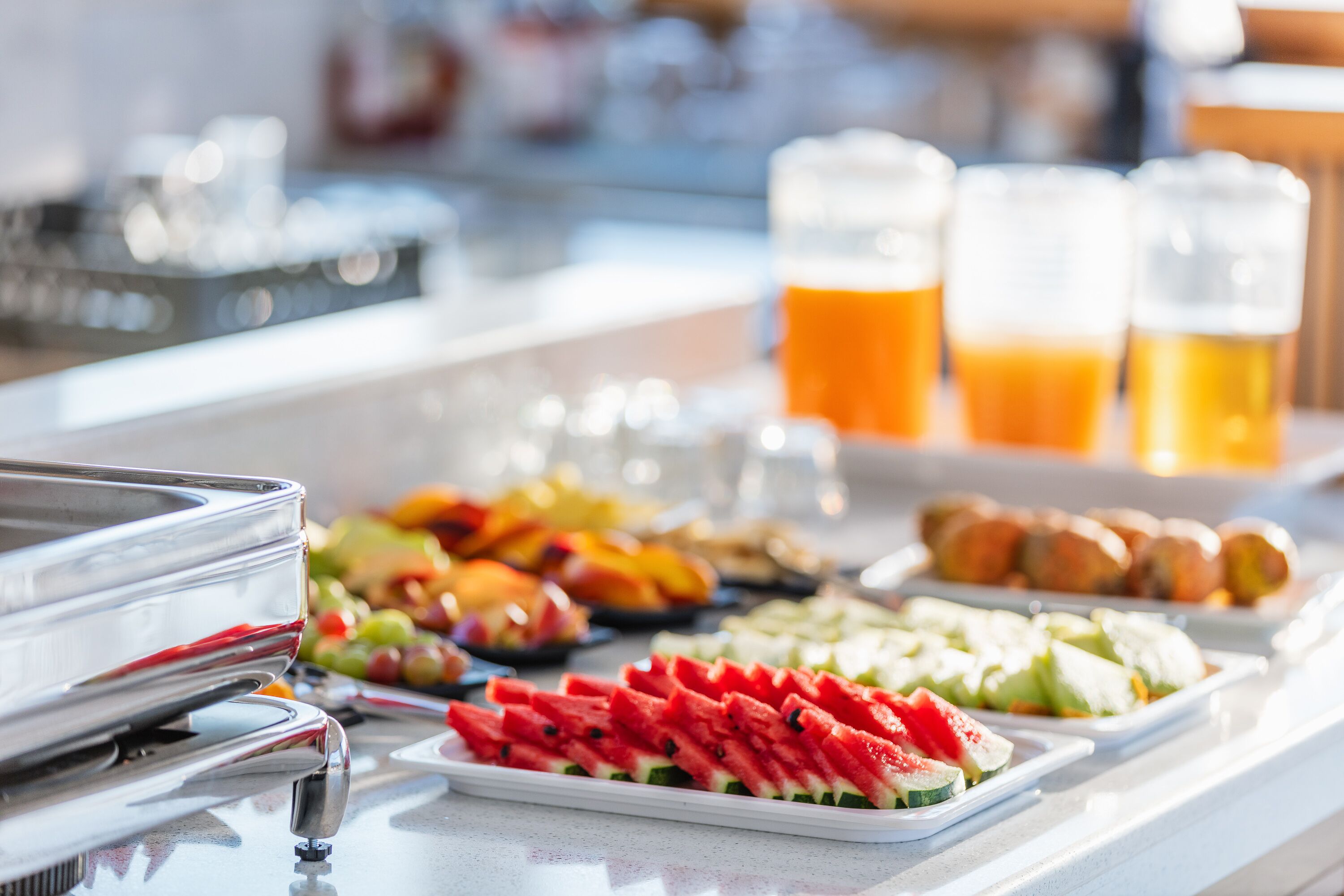 A buffet with various food items and drinks.
