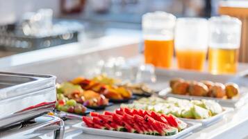 A buffet with various food items and drinks.
