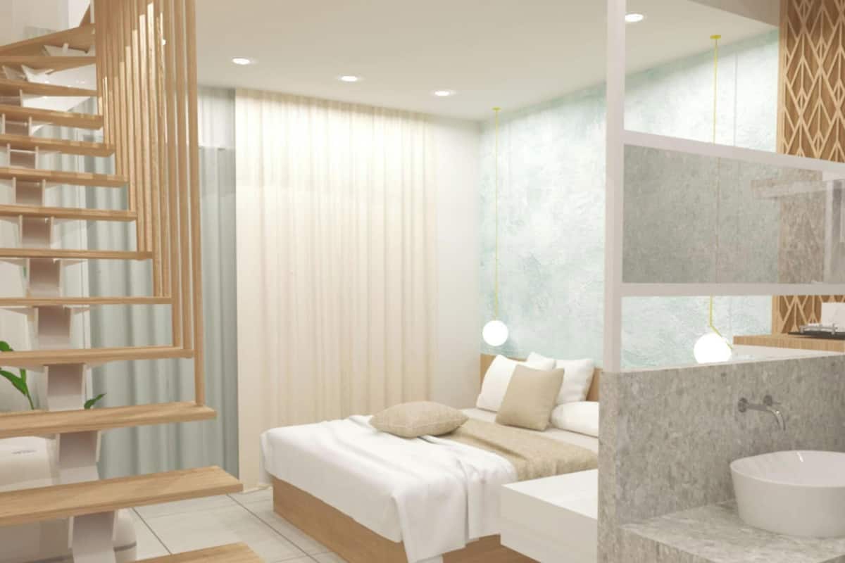 A modern bedroom with a bed, bedside table, and a built-in wardrobe with a wooden ladder.