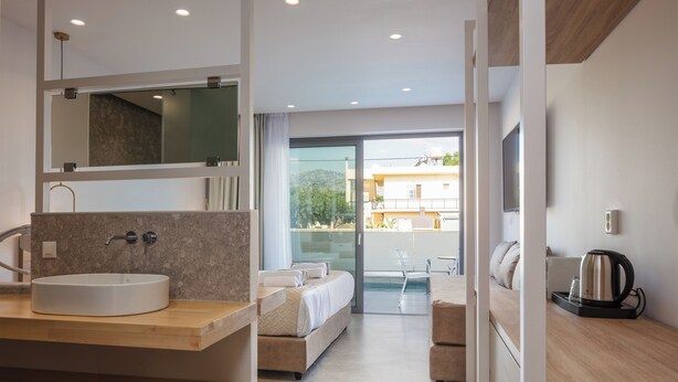 A modern bathroom with a large sink, mirror, and a view to the outside. - Nima Boutique Hotel (Apokoronas)