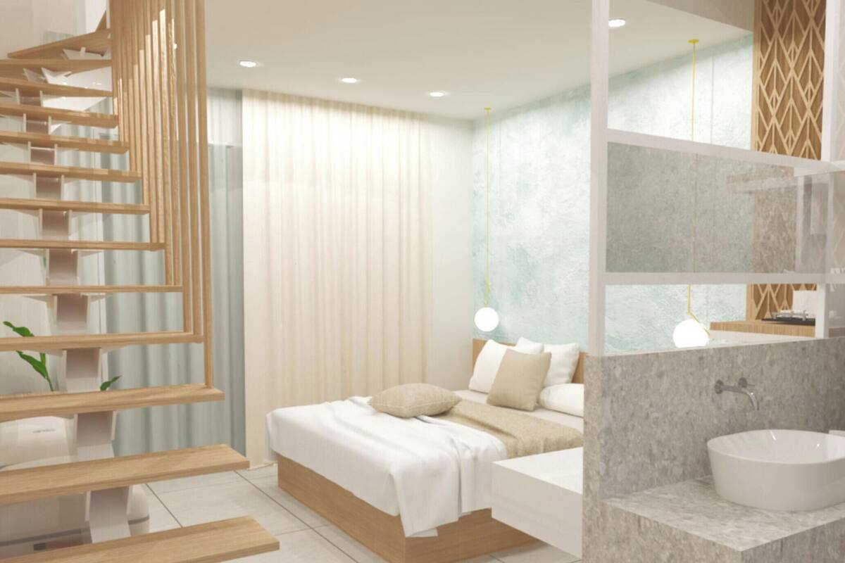 A modern bedroom with a bed, bedside table, and a built-in wardrobe with a wooden ladder.