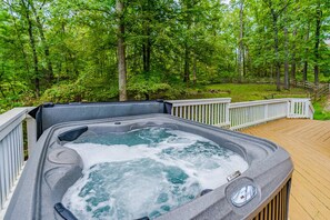 A hot tub on a wooden deck surrounded by a forest. - Hot Tub, Fire Pit, Deck, Grill, WiFi, Dog-Friendly (Gerrardstown)