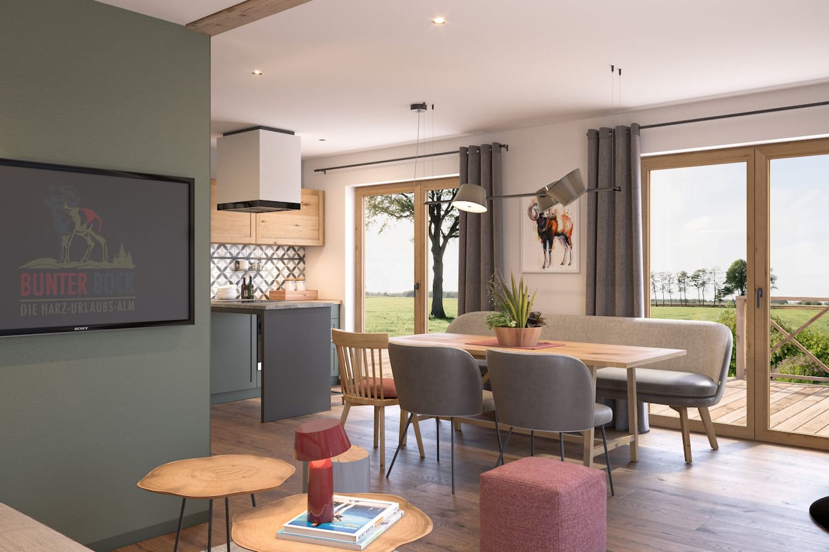 A modern living space with a dining area, kitchen, and large windows offering a view of the outdoors.