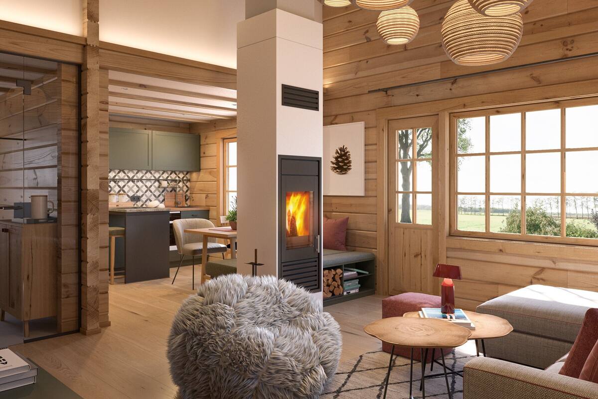 A cozy cabin interior with a wooden interior, a fireplace, a dining area, and a large window offering a view of the outdoors.