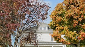A two-story house with a front porch, two chairs, and a mailbox. - Charming Nauvoo Farmhouse - 1 mile from Nauvoo Temple (Nauvoo)