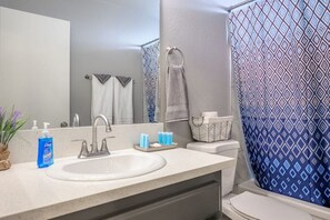Combined shower/tub, hair dryer, towels, soap