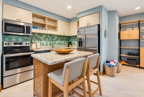 Cocina luminosa con isla y azulejos turquesa