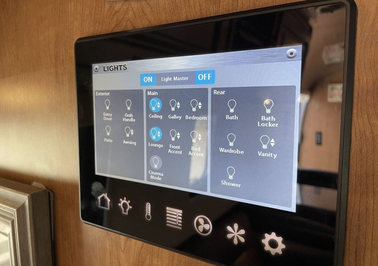 A control panel with various light settings for different areas of a room, including options for exterior, main, and rear lights.