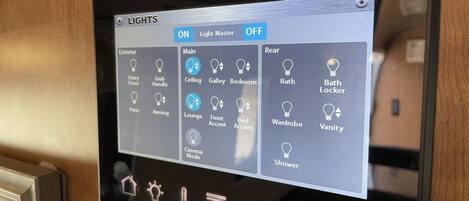 A control panel with various light settings for different areas of a room, including options for exterior, main, and rear lights.