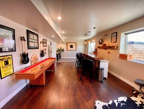 A room with a pool table, bar area, and a view of the outdoors. - Centrally located, clean and comfy (Heber City)