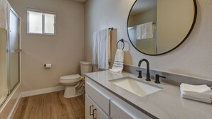 A bathroom with a toilet, sink, and mirror. - **Newly Remodeled Home** 1 mile from Prescott Courthouse! (Prescott)