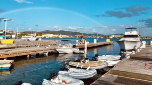 A marina with various boats docked, a wooden pier, and a clear sky. - Oceanfront, Remodeled 2BR- 2 King Size Beds / 2BA Condo at Ocean's View (Christiansted)