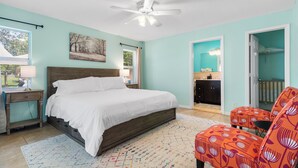 A bedroom with a bed, a desk, a chair, and a ceiling fan. - Pet-Friendly Jupiter Home • Game Room • Central (Jupiter)