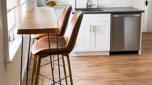 A kitchen with a wooden table and chairs, a dishwasher, and pendant lights. - Elmwood Village 2BR Apt •Sleeps 8• Walk to Dining (Buffalo)