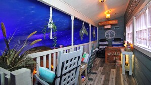 A cozy interior with a starry night mural, wooden furniture, and a sign reading "Relaxin' at Granny's". - Go West- Couples 1-of-a-kind old-time theme-ATL area. (Carroll County)