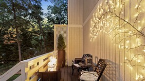 A wooden deck with a fire pit, outdoor seating, and string lights. - Go West- Couples 1-of-a-kind old-time theme-ATL area. (Carroll County)