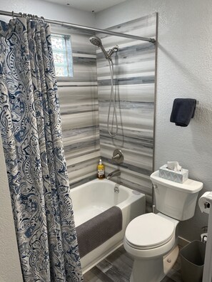 Combined shower/bathtub, hair dryer, towels, soap