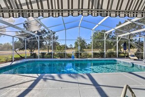 A covered outdoor swimming pool with a clear view of the surrounding landscape.