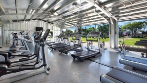 A covered gym with multiple treadmills and exercise equipment. - Oceanfront Condo with Stunning Views & AC (Koloa)