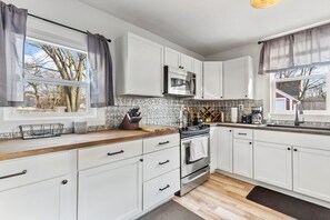 Fridge, microwave, oven, stovetop - Spacious 3BR Getaway Near Downtown & MSU w/ Game Room for a Cozy Winter Retreat (Lansing)