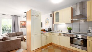 A modern kitchen with a built-in oven, microwave, and sink. - (BIR9a) Apartment Vahle 1 - Apartment "Vahle 1" up to 4 persons ( (Timmendorfer Strand)