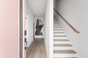 A hallway with a staircase leading to a room. - The Dolly House ♔Vintage Dolly♔Nashville♫Mins To BROADWAY!★9 Beds♥Sleeps 12♥ (Nashville)