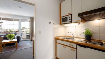 Fridge, microwave, stovetop, coffee/tea maker