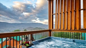 A hot tub with a wooden deck, a bottle of Mercedez wine, and a fruit tray. - Majestic 3BR Smoky Cabin + Views + Small Pet Friendly + Games + Near Dollywood (Pigeon Forge)