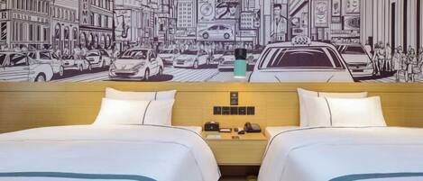 A hotel room with two beds, a wooden headboard, a nightstand with a phone, and a wall mural of a city street scene.