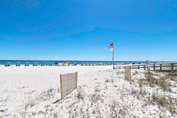 Enjoy the serene beach atmosphere with access to the ocean and an area for relaxation.