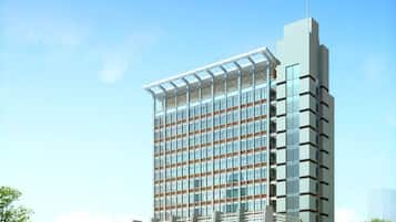 A modern high-rise building with a grid of windows and a flat roof.