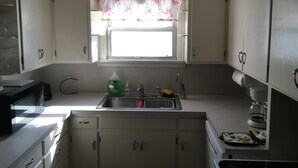 A kitchen with a window, sink, and cabinets. - Classic pretty home with nice patio in Rigby. (Rigby)