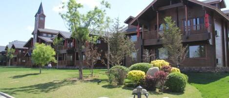 A lodge with a large building, a church, and well-maintained landscaping.
