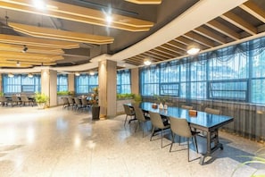 A conference room with a long table, chairs, and large windows. - Oukai'er Hotel (Tonglu)