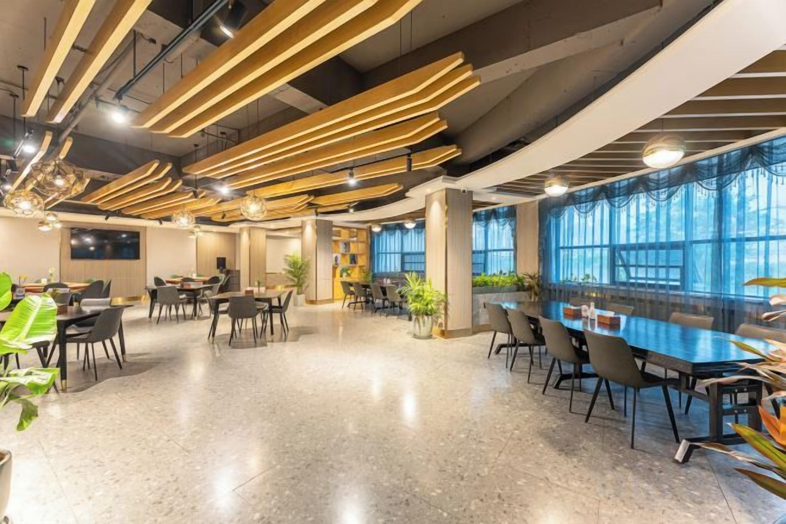 A spacious dining area with high ceilings and modern lighting fixtures.
