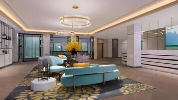 A modern interior with a curved sofa, a chandelier, and a large window.