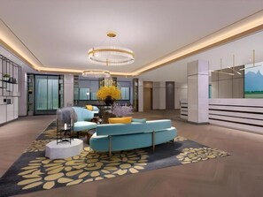 A modern interior with a curved sofa, a chandelier, and a large window.