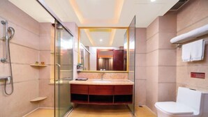 A modern bathroom with a glass shower enclosure, a vanity with a mirror, and a toilet. - Lilai Business Hotel (Dongguan)