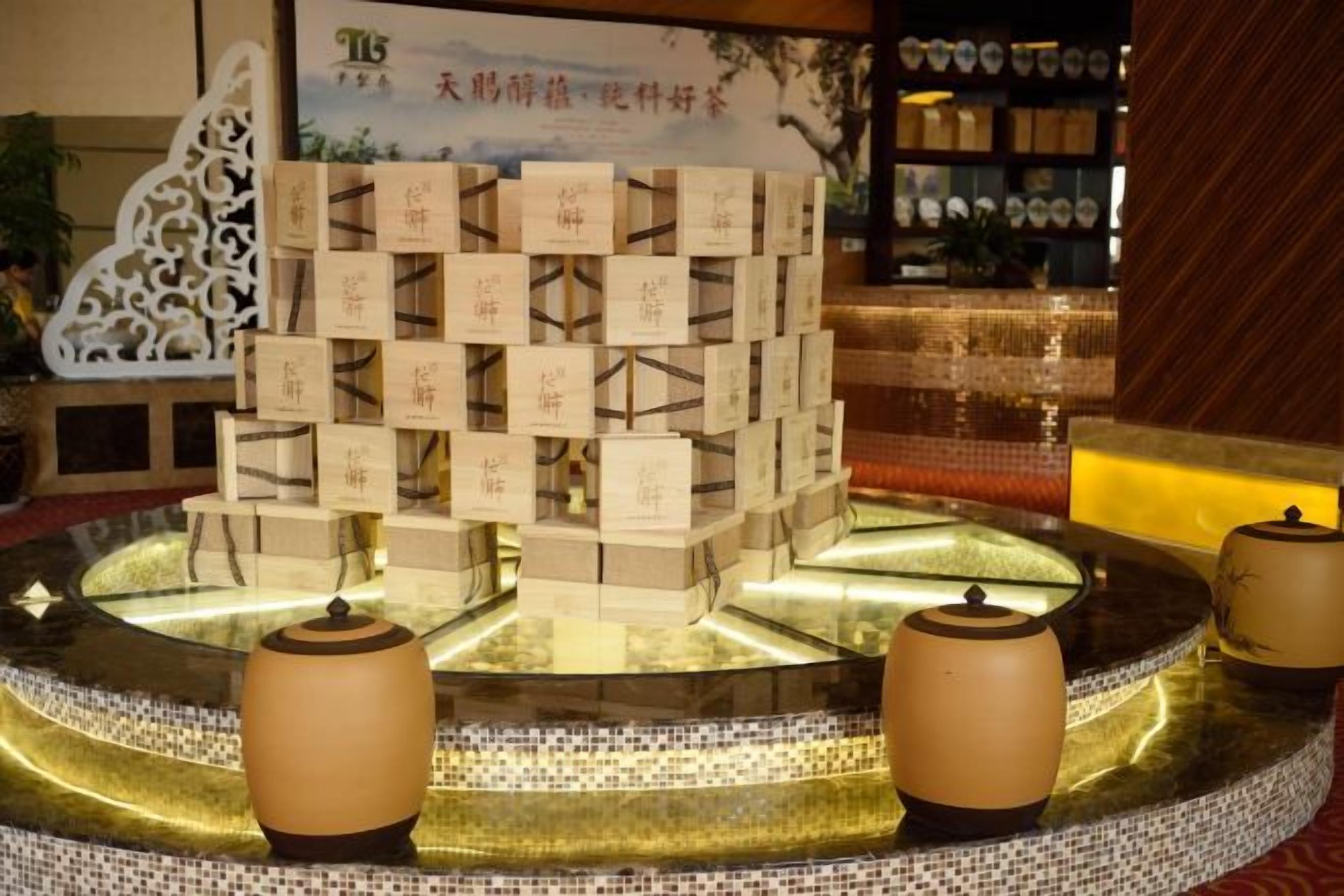 A reception area with a tiered display of boxes, a water feature, and two lamps.