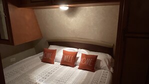 A bedroom with a bed, pillows, and a headboard. - Meri-D sleeps 4 - in Beautiful Lost Pines! (Bastrop)
