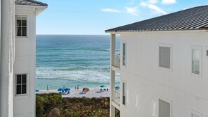 A beachfront building with a view of the ocean.