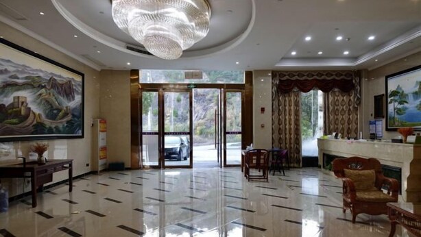 A hotel lobby with a polished floor, a chandelier, a reception desk, and a painting on the wall. - Impression Nanlin Hotel (Nanping)