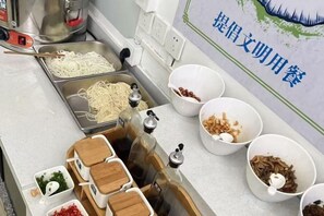 A kitchen counter with various food items and containers. - Impression Nanlin Hotel (Nanping)