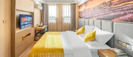 A hotel room with a bed, a desk, a chair, a TV, and a painting on the wall.