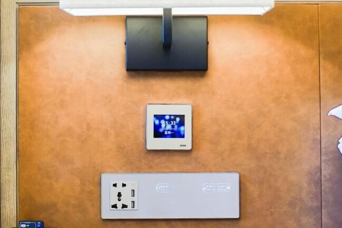 A control panel with a digital clock and a power outlet.