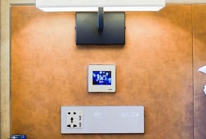 A control panel with a digital clock and a power outlet.