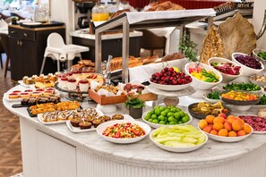 A buffet with various food items including fruits, desserts, and bread. - Mula Hotel - Special Class (Istanbul)