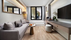 A modern living room with a sofa, coffee table, and a flat-screen TV. - Mula Hotel - Special Class (Istanbul)